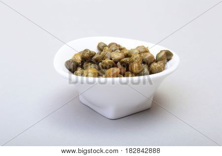bowl with fresh capers isolated on white background