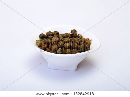 bowl with fresh capers isolated on white background