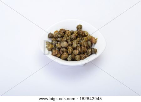 bowl with fresh capers isolated on white background