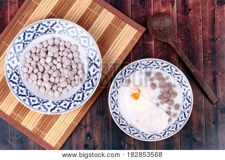Purple Potato Dumplings With Poached Egg And Coconut Roll In Sweet Coconut Cream .