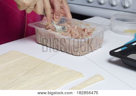 Stages Of Preparation Of Meat Glomeruli. A Woman Stirs Stuffing. Next To The Table Is A Dough And To