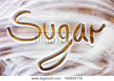 Word sugar written ontop sugar background wooden table