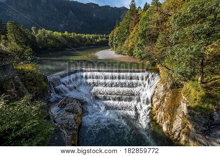 Lech Waterfall in autumn. German countryside on a sunny day