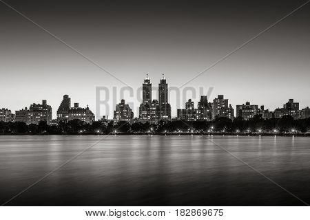 Upper West Side buildings and the Central Park Jacqueline Kennedy Onassis Reservoir at twilight (Black & White). Manhattan New York City
