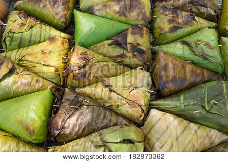 thai street food dessert sweet sticky rice grilled with banana and taro