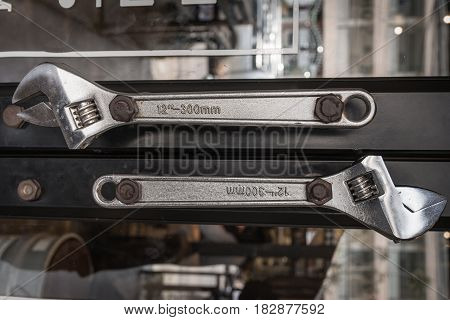 Close up locking steel pliers tool hanging as art on wall