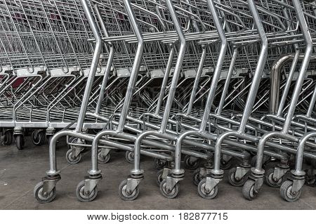 group of shopping carts wheels in front of supermarket