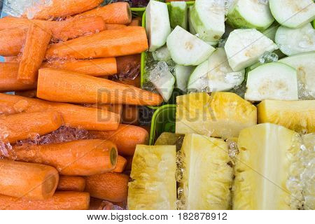 top view of carrot guava and pineapple on ice ready for fresh cool juice in summer