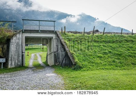 Small tunnel under the railroad with green grass in autumn Switzerland