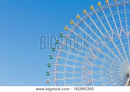 Funfair festival ferris wheel against blue sky background
