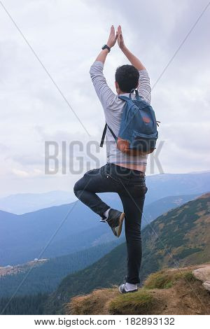 Man standing on edge of mountain, enjoying the beautiful sunset at Carpathians