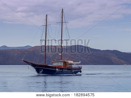 Sailing schooner on the sea road of the port of Athenios. Greece. Santorini.