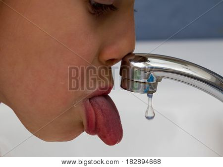 Child Tongue Reaches For A Drop Of Water