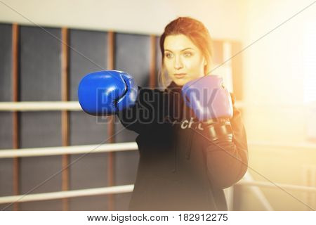 Beautiful Boxing Girl Performs Strong Punch In The Ring. Training At The Gym. Sporty Female Doing Bo