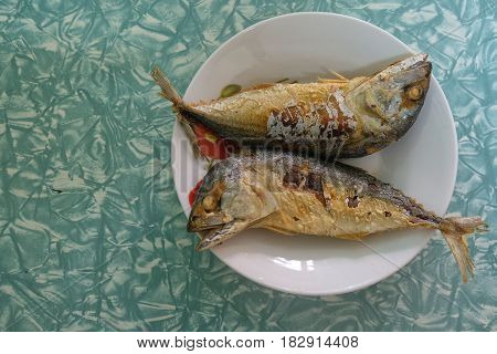 Two mackerel on a plate ready to eat