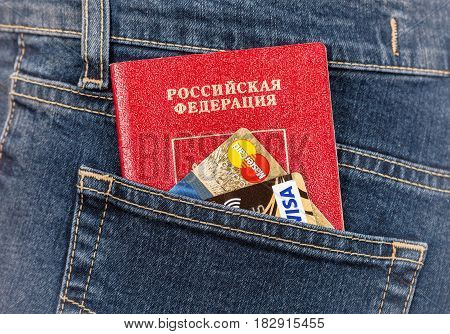 Moscow Russia - November 27 2016: Russian passport credit cards MasterCard and Visa in back jeans pocket. Travel concept