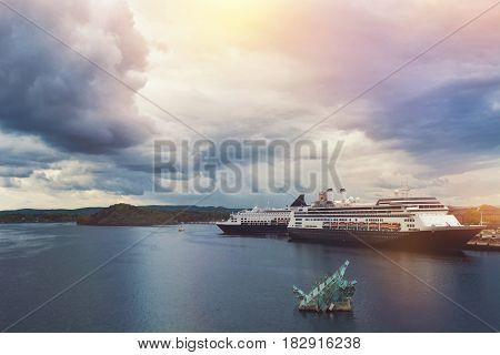 OSLO NORWAY-MAY 19 2016: The floating sculpture in front of the Oslo Opera House namely She Lies made from steel and glass created by italian artist Monica Bonvicini and cruise ships at right side