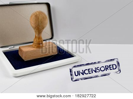 Wooden stamp on a white desk UNCENSORED