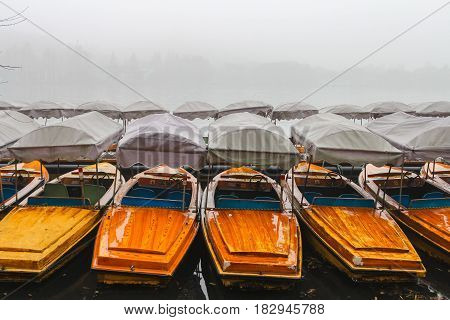 China, Hangzhou, boats on the West Lake in the fog. Many boats waiting for tourists on a misty lake