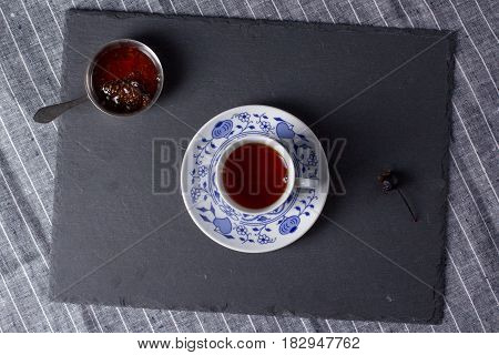 Cup for tea located on a black board top view