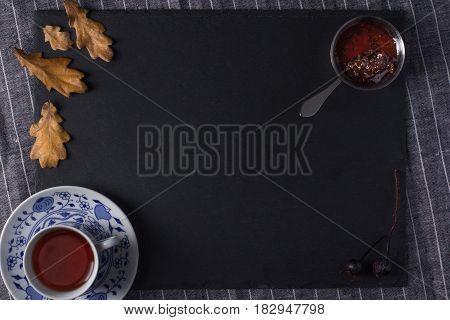 Cup for tea located on a black board top view