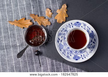 Cup for tea located on a black board top view
