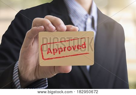 Businessman holding paper writed approved. The flowchart is approved QC and policy for sign symbol passed.