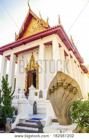 White Thai temple with a Sculpture. with snack statues