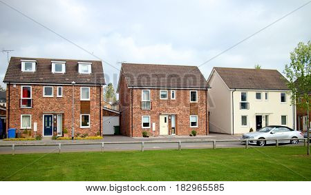 Bracknell, England - April 12, 2017: Three detached houses in a row on a modern housing estate in Bracknell, England.
