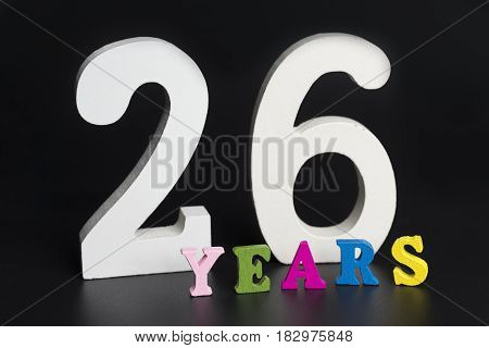 Letters and numbers twenty-six years on a black isolated background.