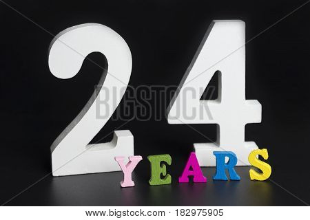 Letters and numbers twenty-four years on a black isolated background.
