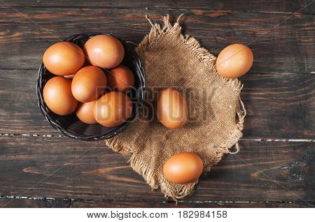 Farm Fresh Brown Chicken Hen Eggs in a Basket on Rustic Wood Counter Background Horizontal