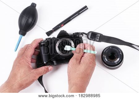 Mirrorless Sensor cleaning and MaintenancePhotographer hand cleaning sensor of camera by using sensor swab and vacuum pumpcleaning dirty camera sensor (CCD or Cmos)