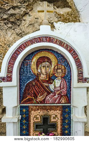 Ostrog, Montenegro - April 10, 2017: Virgin Mary - mosaic icon in rocky Serbian Orthodox Christian monastery Ostrog in mountains of Montenegro. Ostrog - popular place of pilgrimage in Europe.