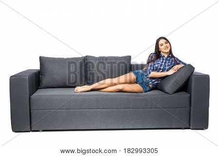 Woman Resting On A Sofa While Looking At The Camera On White Background