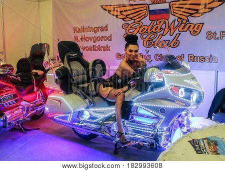 St. Petersburg Russia - 15 April, A model on a neon motorcycle,15 April, 2017.
International Motor Show IMIS-2017 in Expoforurum.
Models on motorcycles presented at the motor show.