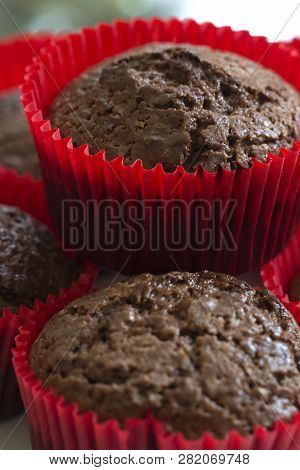 Just Baked Chocolate Muffins. Chocolate Cupcakes. Just Baked Chocolate Cupcakes On A White Wooden Ta