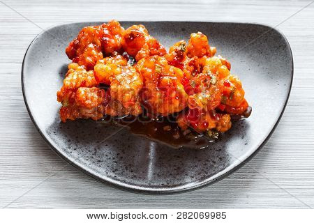 Korean Chinese Cuisine - Above View Of Kkanpunggi Spicy Garlic Fried Chicken Pieces With Vegetables 