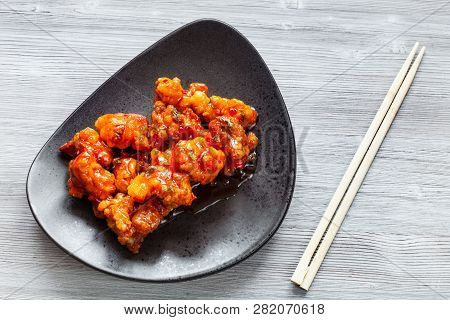 Korean Chinese Cuisine - Top View Of Kkanpunggi Spicy Fried Chicken Pieces With Vegetables In Sweet 