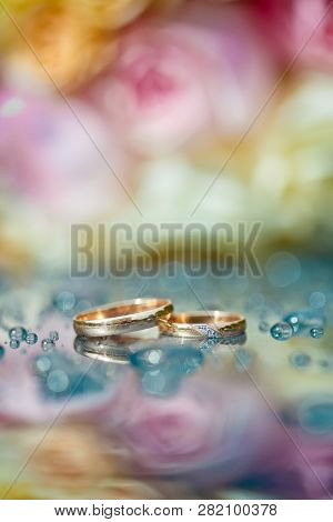 Wedding Rings On Table With Water Drops. Macro.