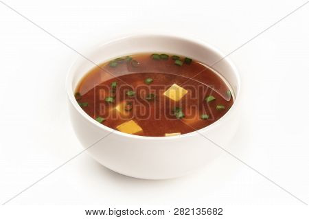 A Photo Of A Bowl Of Miso Soup With Tofu And Scallions On A White Background With Copy Space