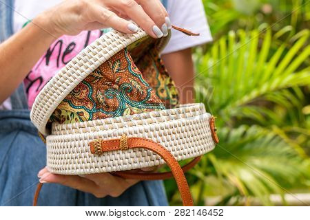 Woman Hands With Stylich Eco Friendly Rattan Bag On A Tropical Background. Bali Island.