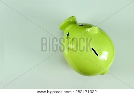 Creative Background, Green Pig Money Box On Gray Background Top View, Flat Lay. The Concept Of Savin