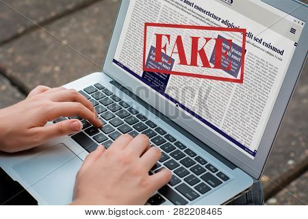 Closeup Of Young Woman Reading Digital Fake News On Laptop. Propaganda And Disinformation Online. Me