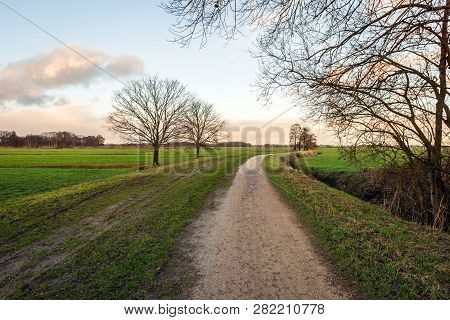 Curved Sand Path In A Dutch Polder Landscape In The Winter Season. The Photo Was Taken In The Binnen