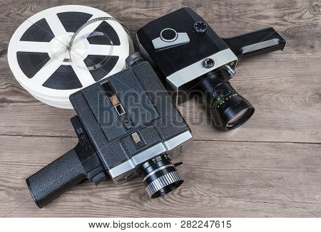 Two Old Vintage Amateur Film Movie Cameras Powered By Clockwork Motor And Electric Motor And Reels O