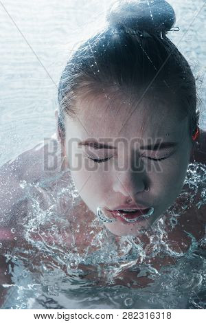 Close Up Of Young Woman Posing Underwater With Closed Eyes