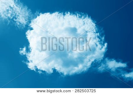 Round Fluffy Cloud In Clear Blue Sky. Peaceful Cloudy Sky Natural Background, Frame. Sunny Day, Ligh