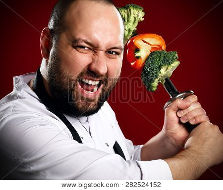 Bearded Professional Chef In White Skirt Going To Fight With Skewer With Vegetables On It Kebab On K