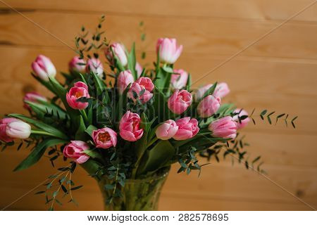 A Bouquet Of Pink Tulips In A Beautiful Crystal Vase On Wooden Background. Spring